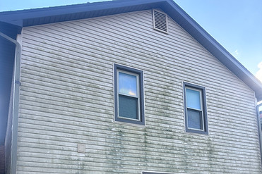 Photo of dirty siding on a residential home that desperately needs a power washing service