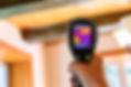 Technician using a thermal imaging camera to identify hidden moisture during a professional water damage inspection in Boise, Idaho
