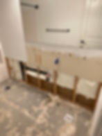 Before water damage restoration showing drywall removed after a burst plumbing pipe leaked behind a bathroom vanity in a Treasure Valley home