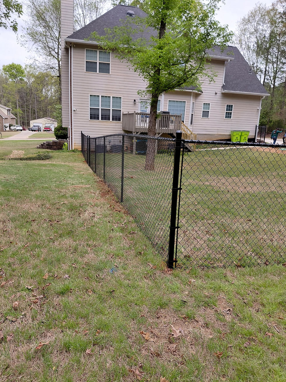 Black Chain Link Fence installed to secure backyard professionally installed
