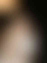 bride sitting on grooms lap laughing