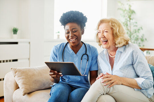Eye-level view of a caregiver assisting an elderly woman in her home