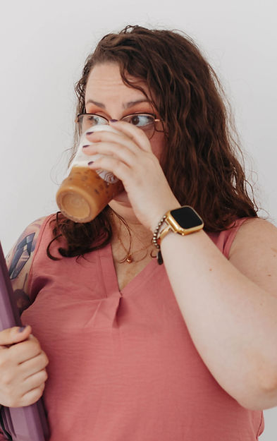 LGBTQ-affirming therapist Shannon Bruckner enjoying coffee in a warm, welcoming setting