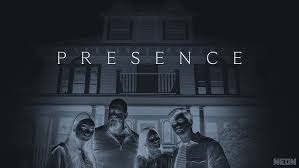 A family is standing in front of a house