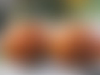 two carved pumpkins on a table outdoors