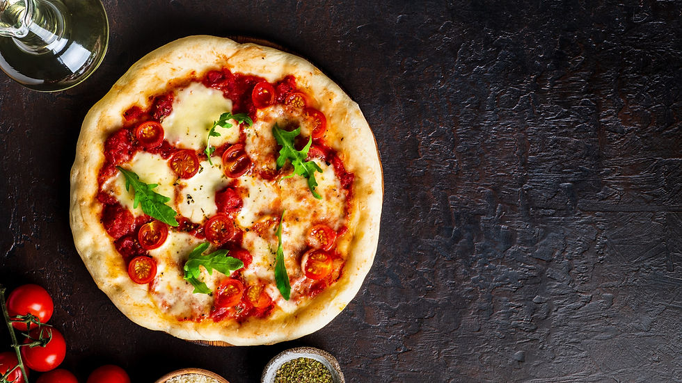 hot homemade Italian pizza margherita with mozzarella and tomatoes on dark brown stone tab