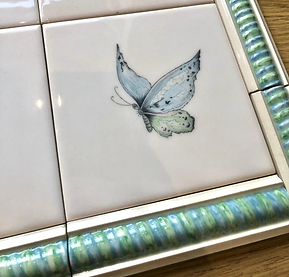 “Large hand‑painted chinoiserie tile panel with birds, flowers, and botanical patterns for luxury bathrooms.”