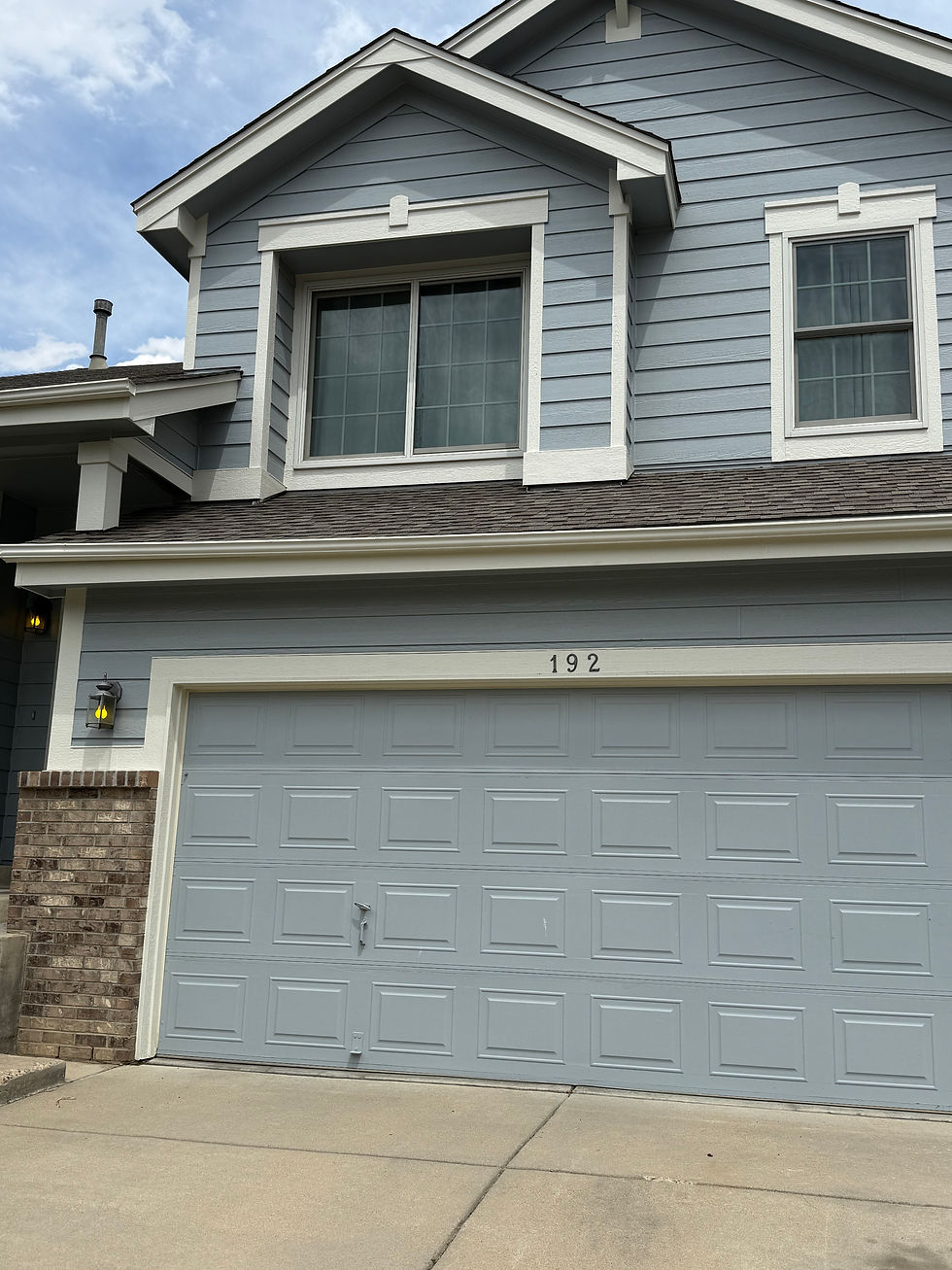 Look for the blue house on the East side of the street with the "192" above the garage.