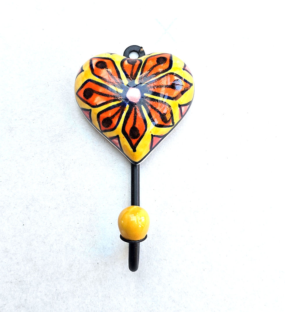 Rustic wooden coat rack with colourful ceramic heart hooks in orange and yellow floral design