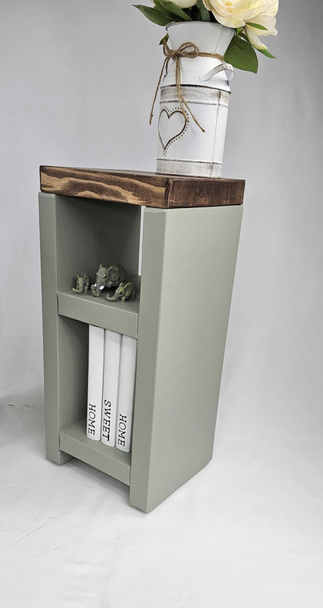 Slim wooden side table styled as bedside and lamp stand