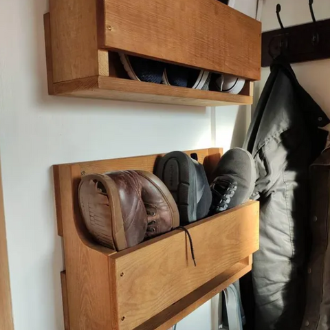 Wooden wall-mounted shoe organizers with various pairs of shoes