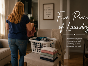 A cozy living room with a laundry basket beside an upholstered chair holding five neatly folded pieces of clothing. Soft natural light, neutral décor, and a peaceful setting create a warm, inviting atmosphere.