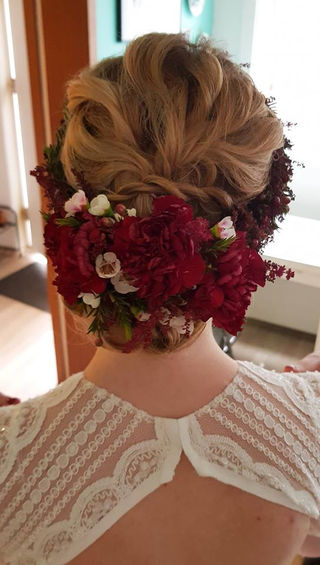 bridal low bun with flowers in hair