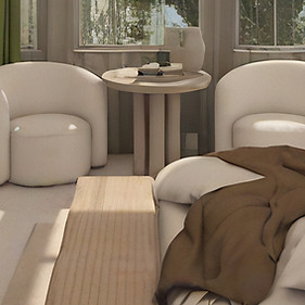 A cozy modern bedroom with a large bed, wood furniture, abstract wall art, and a small seating area by tall windows with green curtains