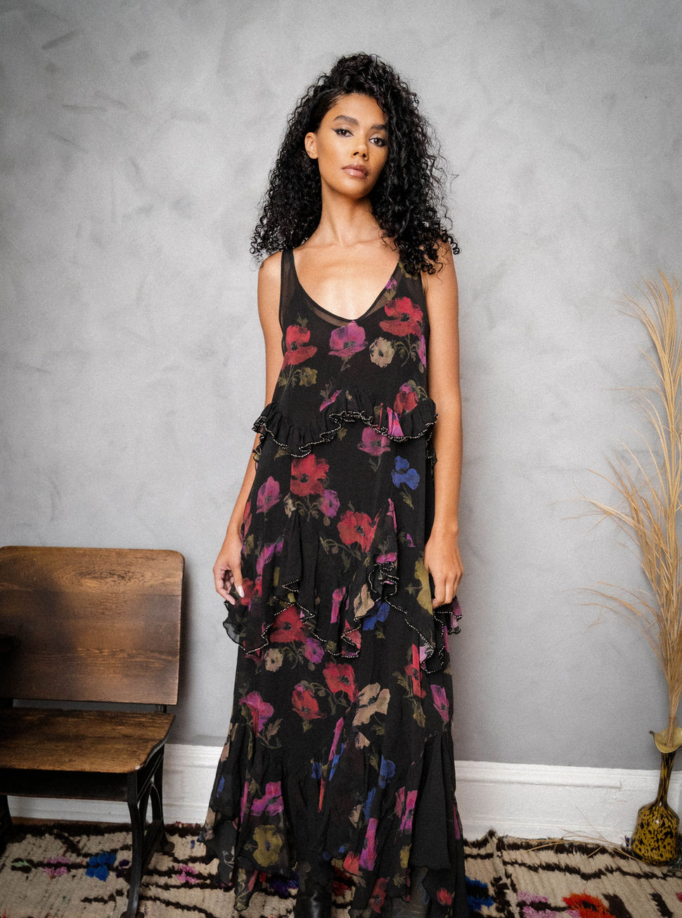 Woman wearing the ROSE CALLEY RUFFLE DRESS striking a pose with her hand to her side