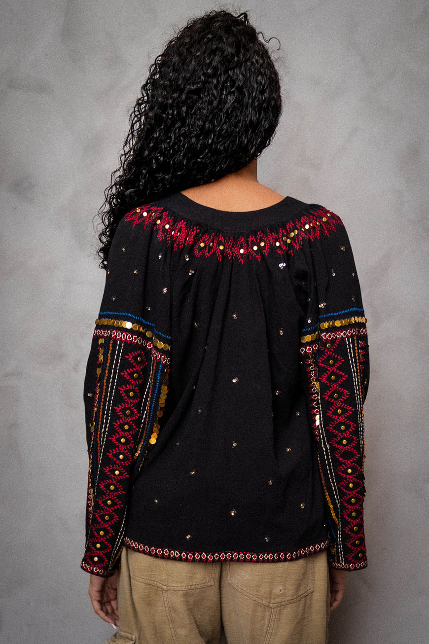 Woman wearing khakis and a MARRAKECH TOP striking a pose looking away