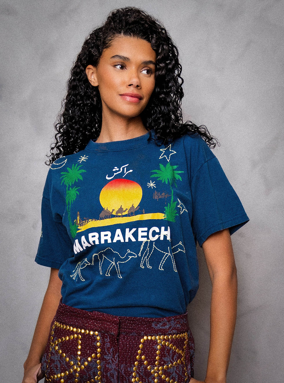 Woman wearing a MARRAKECH TEE striking a pose with her hands partly in her pockets