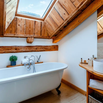 Claw foot bath in wooden roof room