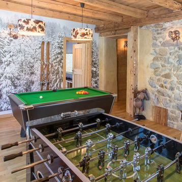 Game room with wooden ceiling & lime rendered stone wall