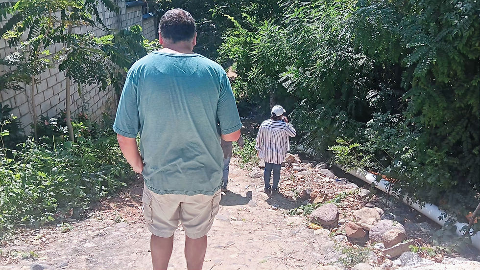 Steven, Gilma, and Angel heading down the incline to visit families