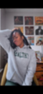 Aris Miller, a vinyl enthusiast and collector poses in front of her vinyl record wall in what she considers her sacred space.