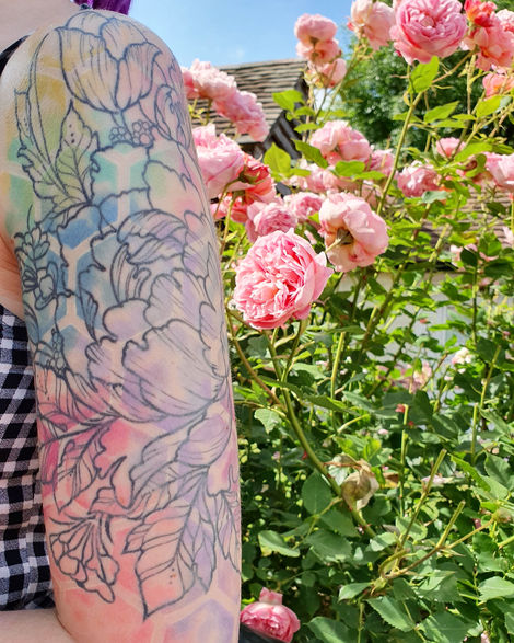 Watercolour patterns and flowers tattoos in a summer garden