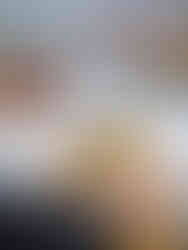 A plate of pasta with sea food and a person holding their cutlery ready to eat the dish