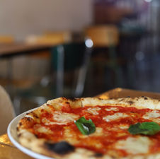a pizza on a wooden table in a Italian restaurant in Sagres