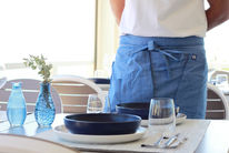 A waiter serving a table at Castelo beach club