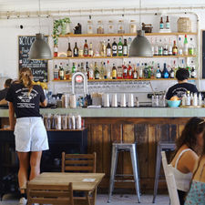 a bar and tables at a cafe in sagres