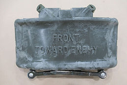 A Claymore mine labeled "Front Toward Enemy" is displayed, highlighting its use in military operations.