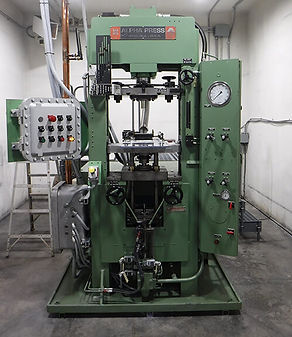 An explosive pressing machine in operation, precisely forming explosive pellets, demonstrating advanced manufacturing techniq