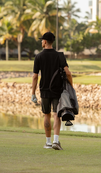 Man holding clubs on golf course