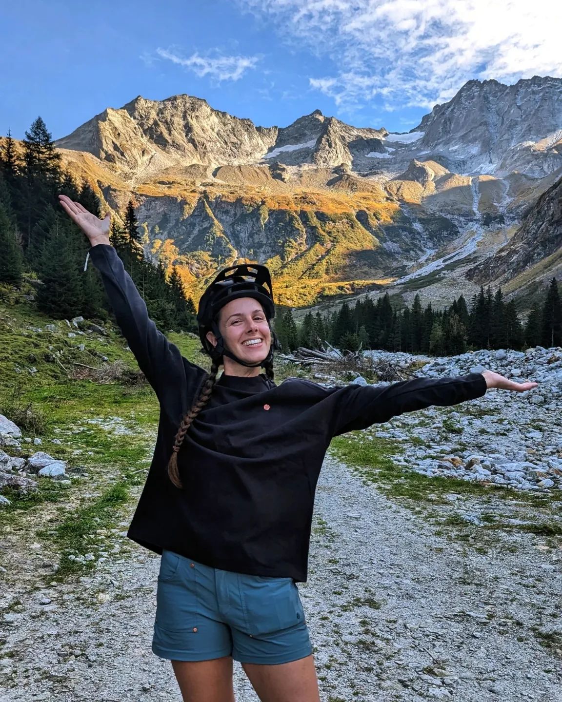 Happy girl mountain biking in the mountains of Austria