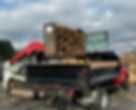 Loader adding wood to a dump truck