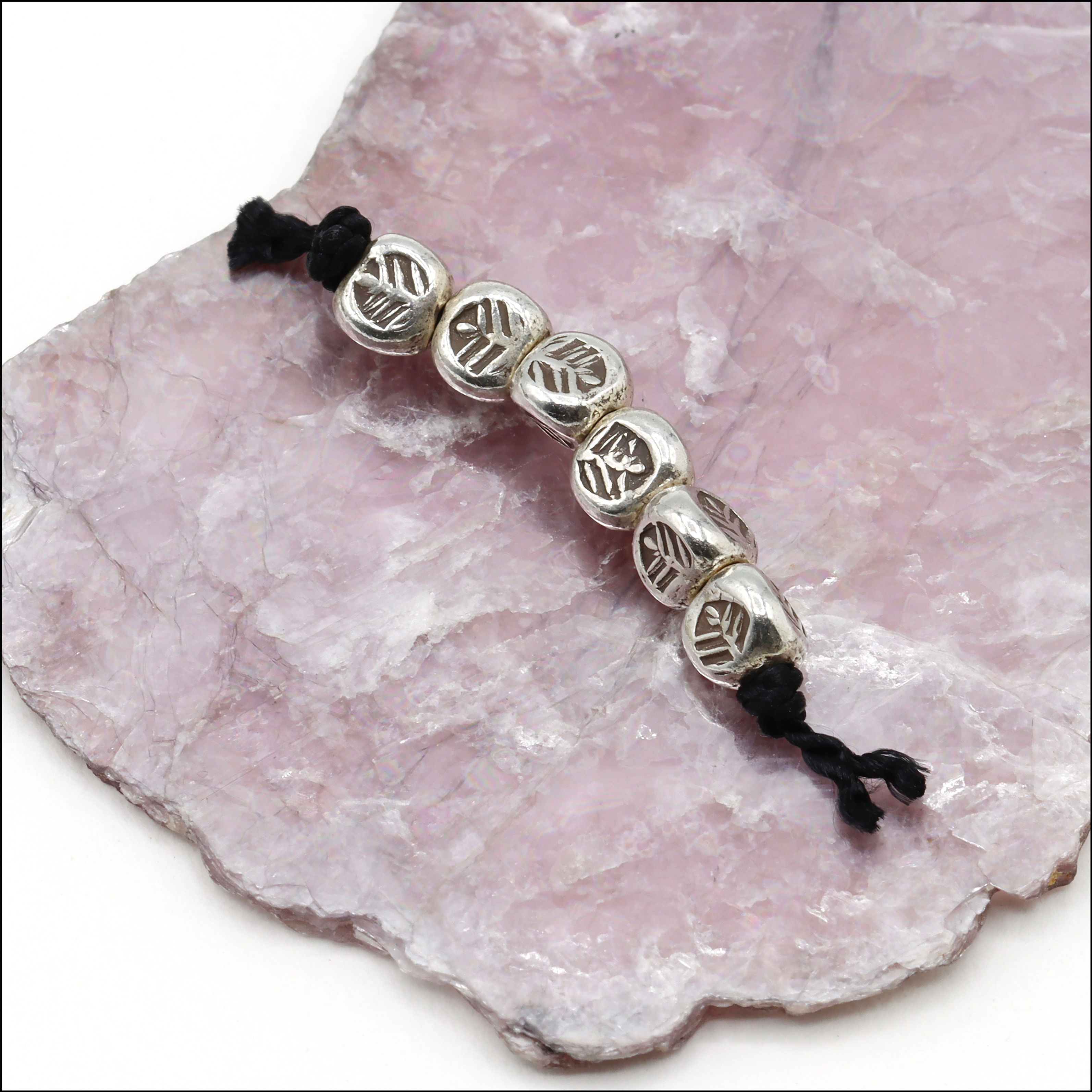 Hill Tribe Silver 3-sided feather stamped bead measures 4.5mm x 4.5mm x 4.5mm with a 1.2mm hole.