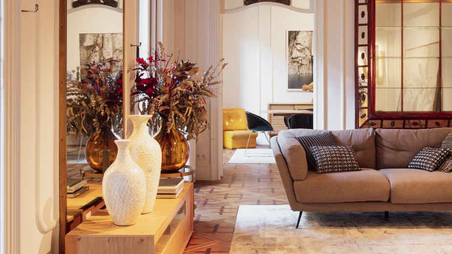 Close-up view of a cozy living room with earth tones and green plants