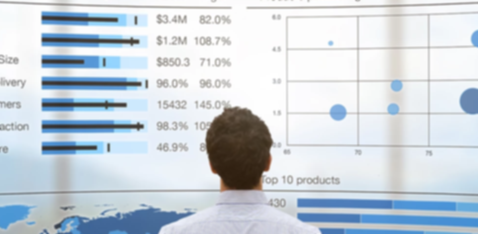 Businessman analyzing a business analytics (BA) or intelligence (BI) dashboard on virtual