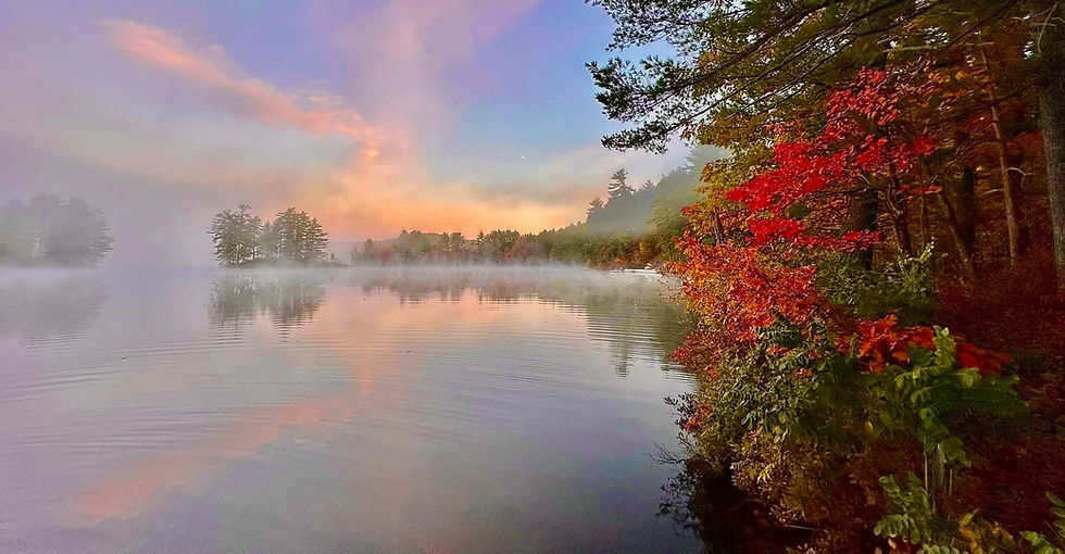 Peak fall foliage at sunrise on Belleau Lake in Wakefield New Hampshire