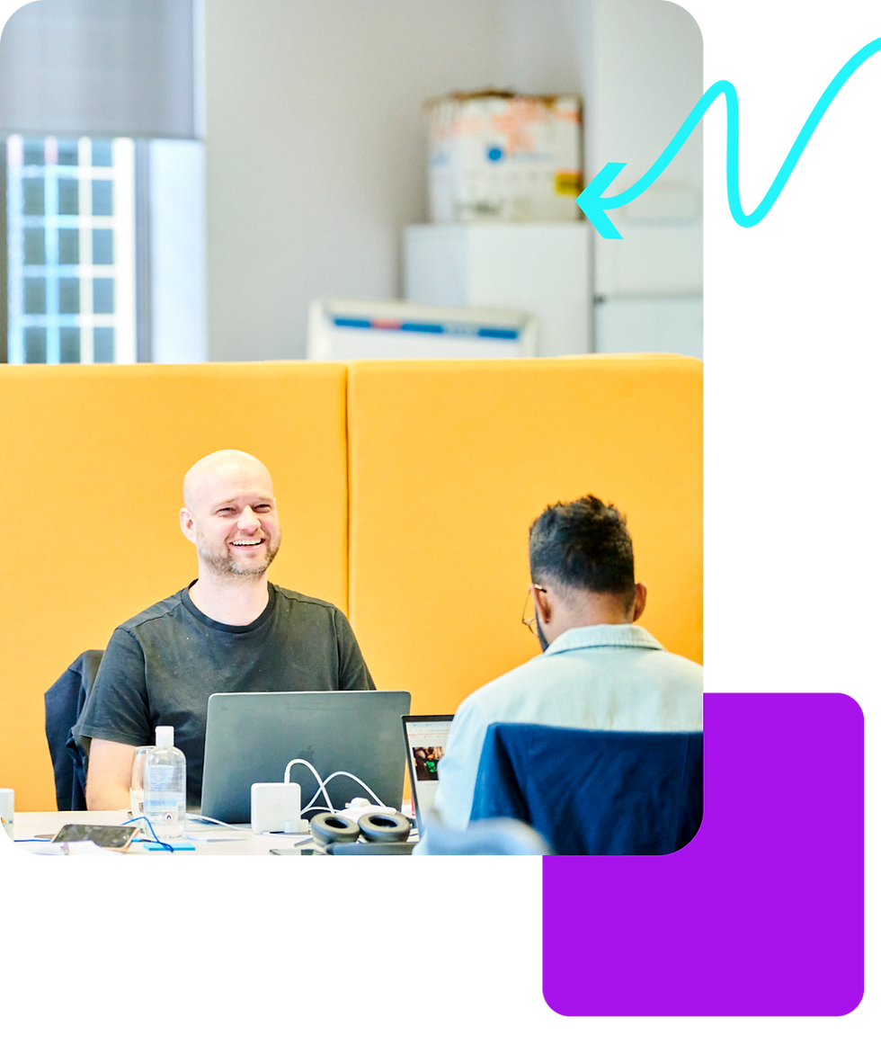 two people sat together in a modern office environment
