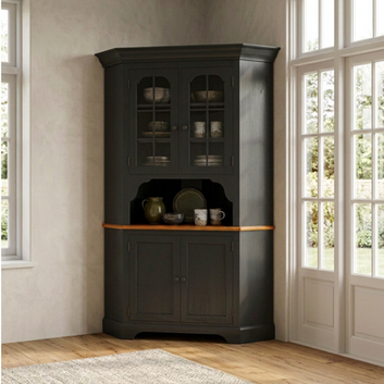 Early American corner hutch in soft maple with glass upper doors and paneled lower cabinet, painted in Historic Charcoal and shown in a bright interior setting