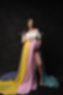 Woman in rainbow-skirted maternity gown at Eugene Oregon photo studio