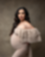 Woman in profile shows off her pregnant belly during her maternity photoshoot