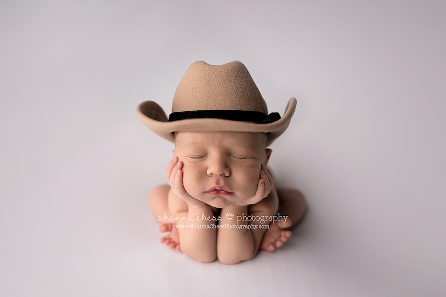 baby boy in froggy pose wearing cowboy hat