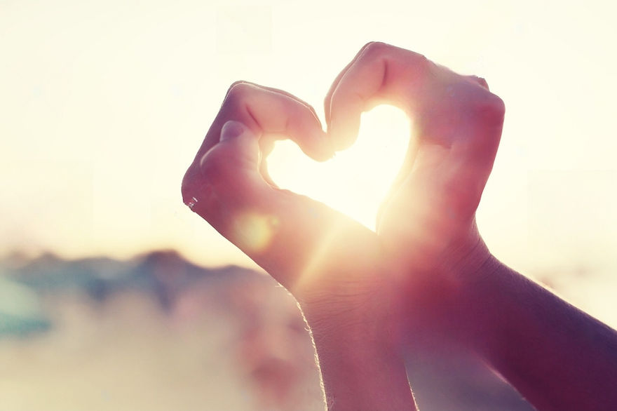 stock-photo-hands-in-heart-shape-framing-setting-sun-at-sunset-on-beach-755088646-transfor