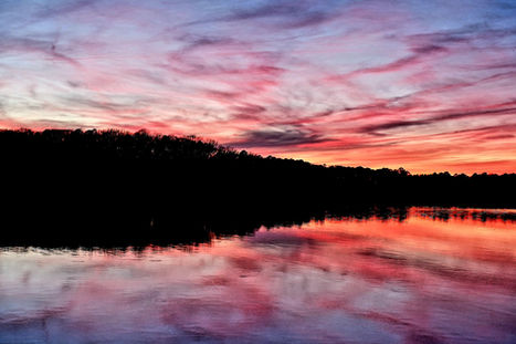 a photograph of a lake at sunset