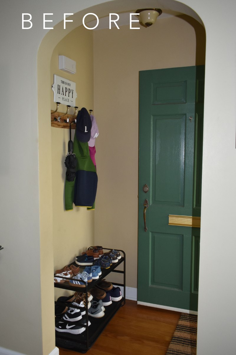 entryway with green door open, wall hooks with jackets, shoe storage rack
