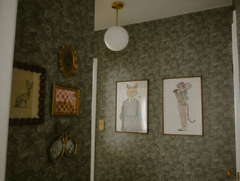 hallway gallery wall on green botanical wallpaper