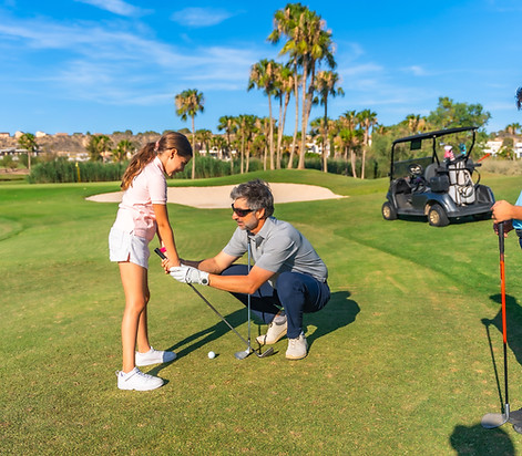 coach-teaching-girl-her-brother-play-golf.jpg
