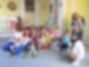 Families with Young Children Retreat, kids and staff sit on porch step next to kitchen entrance